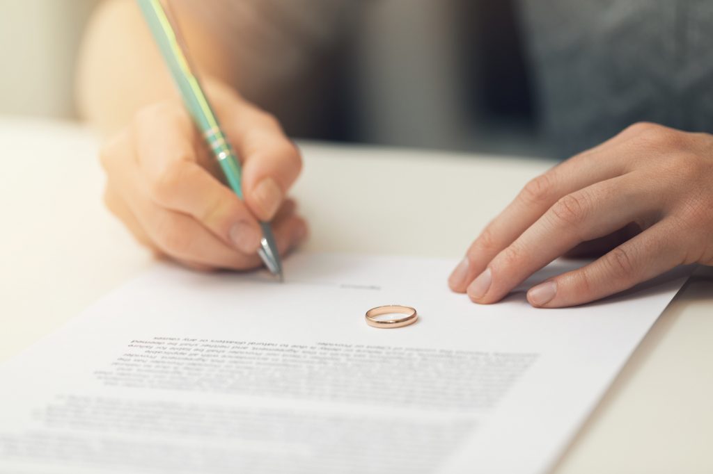 Woman Signing Divorce Documents