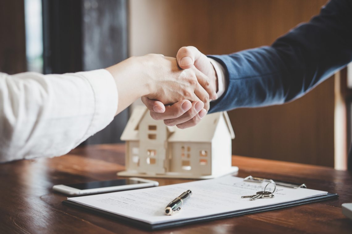 Real estate lawyer and customers shaking hands Allen Gabe Law P.C.