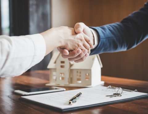 Real estate lawyer and customers shaking hands Allen Gabe Law P.C.